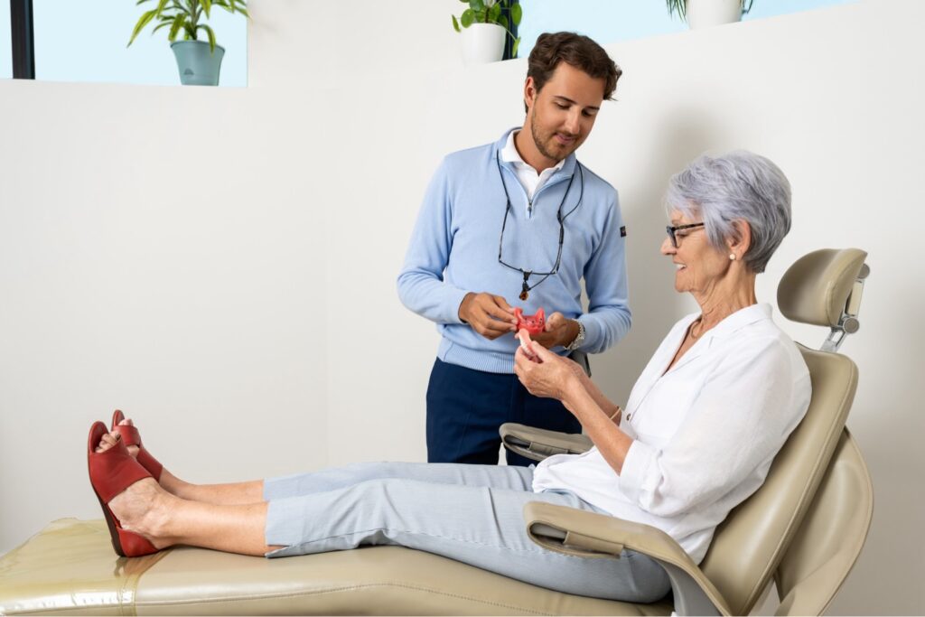 Denturist reviewing fit of dentures with patient