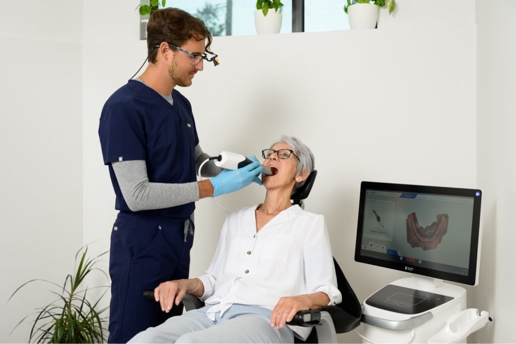 Denturist using digital denture scanner on patient at Dieppe Denture clinic